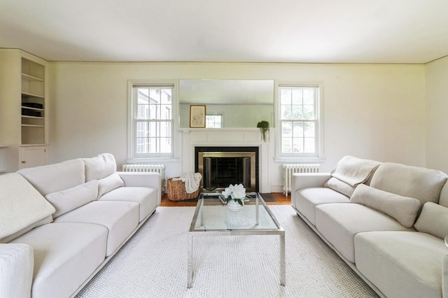 50 Overlook Dr, Chappaqua, NY 10514 - living area with radiator, plenty of natural light, a fireplace with flush hearth, and wood finished floors