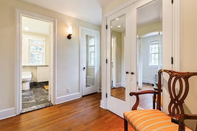 50 Overlook Dr, Chappaqua, NY 10514 - sitting room featuring french doors, arched walkways, and wood finished floors