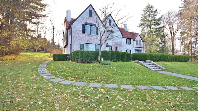 50 Overlook Dr, Chappaqua, NY 10514 - view of home's exterior with a chimney, a yard, and brick siding