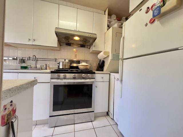 220-34 67th Ave Duplex, Unit Duplex, Bayside, NY 11364 - kitchen with freestanding refrigerator, stainless steel gas range, under cabinet range hood, light countertops, and backsplash