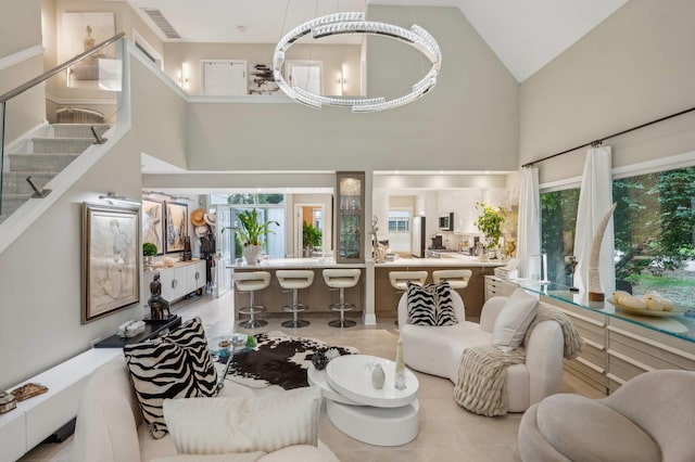 545 Hampton Rd Unit 16, Southampton, NY 11968 - living room with high vaulted ceiling, stairs, plenty of natural light, and tile patterned floors
