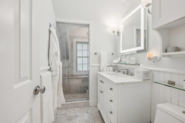 545 Hampton Rd Unit 16, Southampton, NY 11968 - bathroom with marble look tile flooring, vanity, a stall shower, and wainscoting