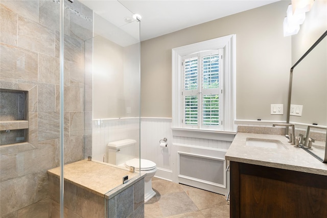 121 Overlook Cir, New Rochelle, NY 10804 - bathroom with vanity, tiled shower, and a wainscoted wall