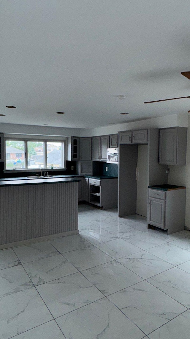 127 Forest Ave, Massapequa, NY 11758 - kitchen with light marble finish floors, gray cabinets, and wall oven
