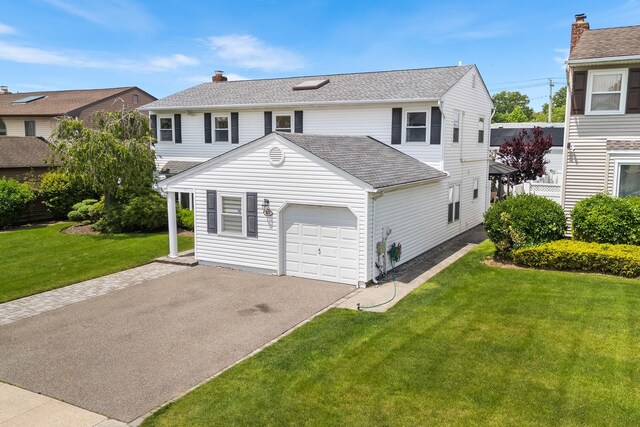 427 Benito St, East Meadow, NY 11554 - view of front of home with an attached garage, a front yard, asphalt driveway, and a shingled roof