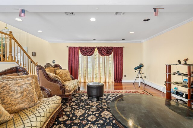 427 Benito St, East Meadow, NY 11554 - living area featuring ornamental molding, wood finished floors, stairs, and recessed lighting