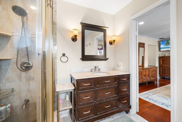 427 Benito St, East Meadow, NY 11554 - full bathroom featuring a stall shower, vanity, wood finished floors, and ornamental molding
