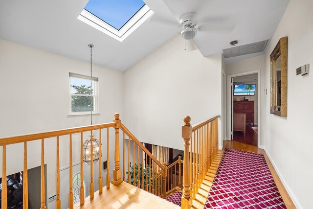 427 Benito St, East Meadow, NY 11554 - corridor with an upstairs landing, wood finished floors, a skylight, and vaulted ceiling
