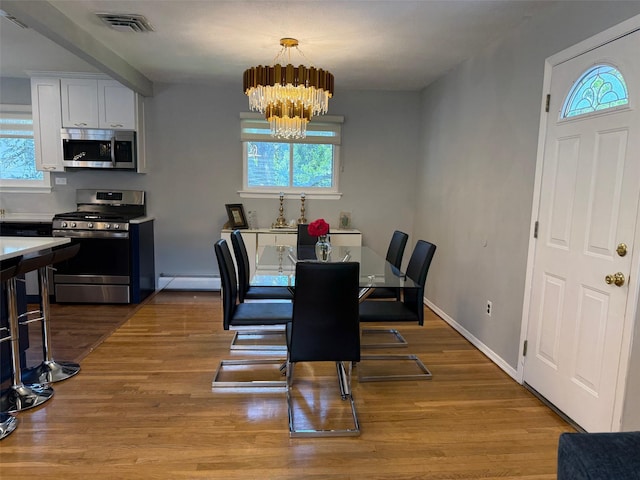 226LAURIELANE Laurie Ln, West Hempstead, NY 11552 - dining area with plenty of natural light, a chandelier, and wood finished floors