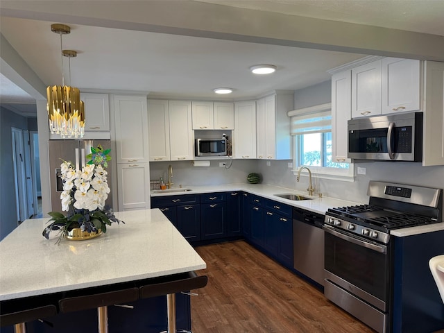 226LAURIELANE Laurie Ln, West Hempstead, NY 11552 - kitchen featuring stainless steel appliances, blue cabinetry, dark wood finished floors, white cabinetry, and a chandelier
