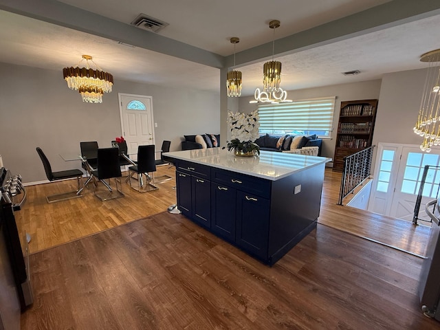 226LAURIELANE Laurie Ln, West Hempstead, NY 11552 - kitchen with a chandelier, light countertops, dark wood finished floors, open floor plan, and stainless steel range oven