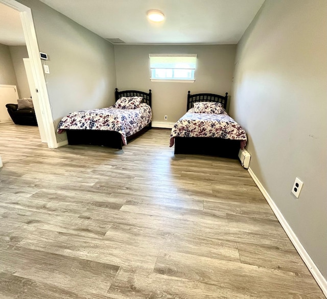 226LAURIELANE Laurie Ln, West Hempstead, NY 11552 - bedroom featuring wood finished floors and a baseboard radiator