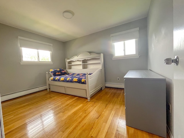 226LAURIELANE Laurie Ln, West Hempstead, NY 11552 - bedroom with a baseboard radiator, baseboard heating, multiple windows, and light wood-style floors