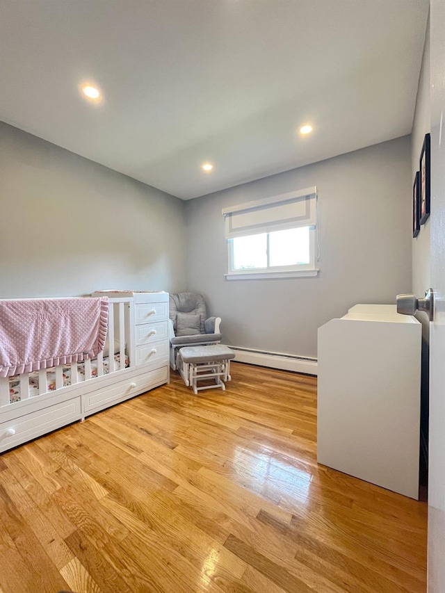 226LAURIELANE Laurie Ln, West Hempstead, NY 11552 - bedroom featuring a baseboard heating unit, wood finished floors, and recessed lighting