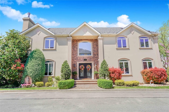 30 Aviva Ct, Staten Island, NY 10307 - view of front facade featuring stucco siding, a chimney, and french doors