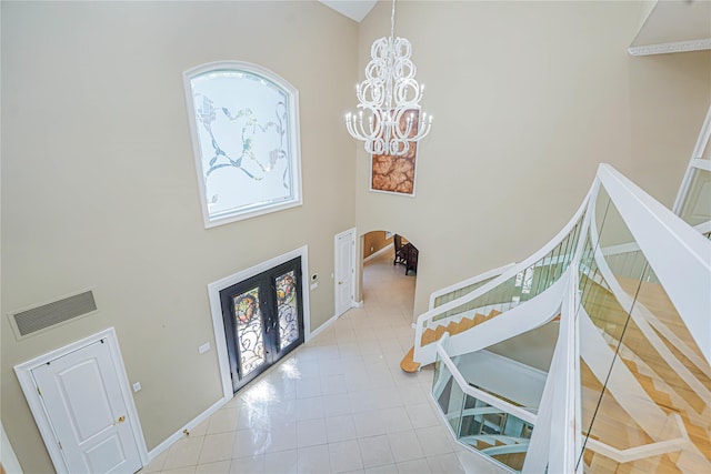 30 Aviva Ct, Staten Island, NY 10307 - entryway featuring a high ceiling, a chandelier, arched walkways, tile patterned flooring, and stairway