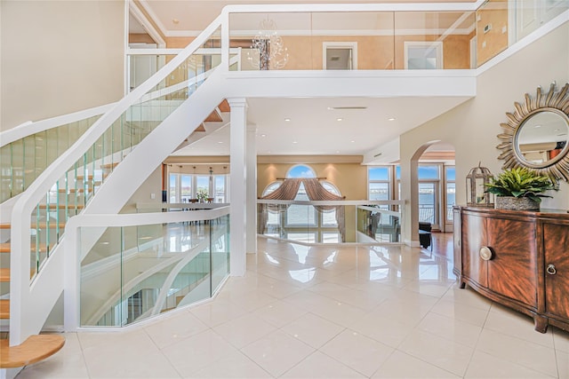 30 Aviva Ct, Staten Island, NY 10307 - stairway with healthy amount of natural light, arched walkways, a high ceiling, tile patterned floors, and crown molding