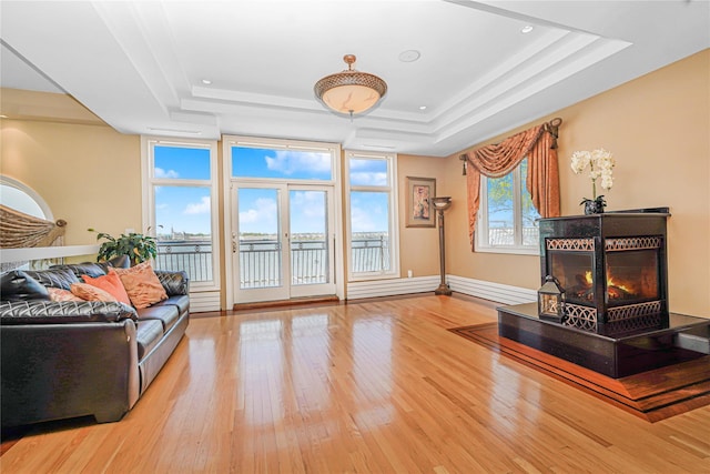 30 Aviva Ct, Staten Island, NY 10307 - living room with a tray ceiling, light wood-style floors, a warm lit fireplace, a water view, and recessed lighting