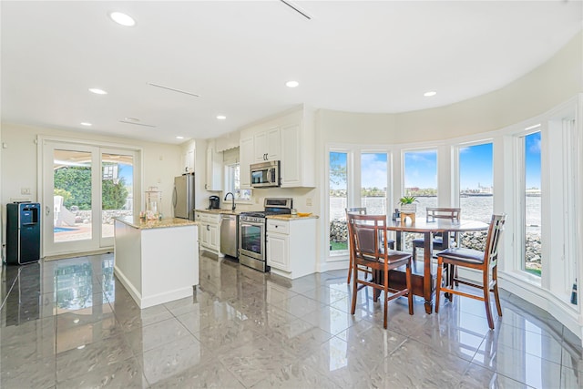 30 Aviva Ct, Staten Island, NY 10307 - kitchen featuring stainless steel appliances, a center island, a water view, white cabinetry, and recessed lighting