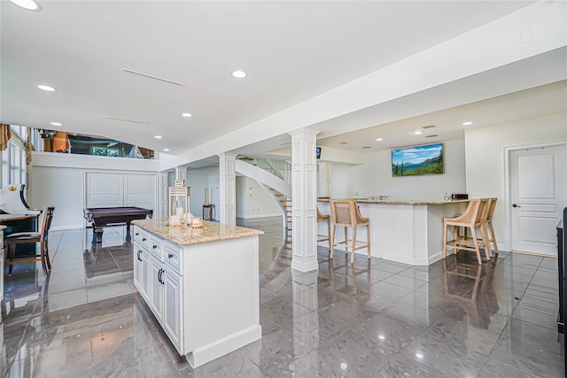 30 Aviva Ct, Staten Island, NY 10307 - kitchen featuring a breakfast bar area, light stone counters, recessed lighting, ornate columns, and billiards