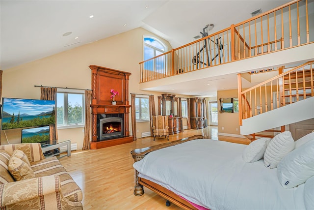 30 Aviva Ct, Staten Island, NY 10307 - bedroom featuring wood finished floors, a lit fireplace, high vaulted ceiling, and a baseboard radiator