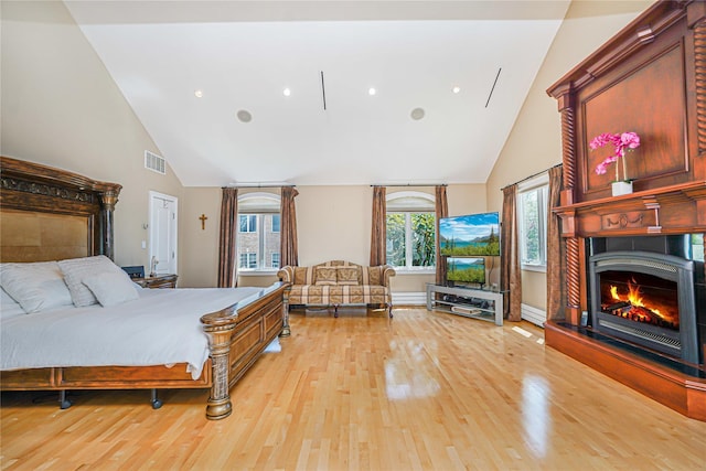 30 Aviva Ct, Staten Island, NY 10307 - bedroom with high vaulted ceiling, light wood-style floors, a lit fireplace, a baseboard heating unit, and recessed lighting
