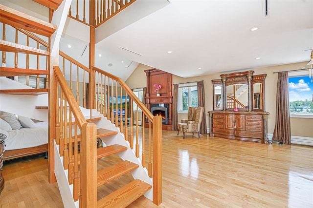 30 Aviva Ct, Staten Island, NY 10307 - staircase featuring wood finished floors, a warm lit fireplace, and recessed lighting