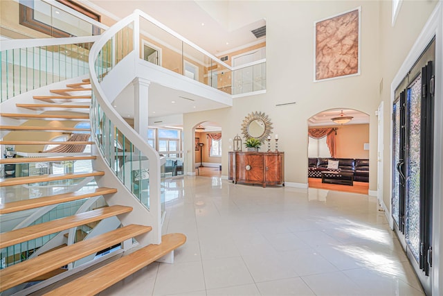 30 Aviva Ct, Staten Island, NY 10307 - staircase with arched walkways, a towering ceiling, and tile patterned floors