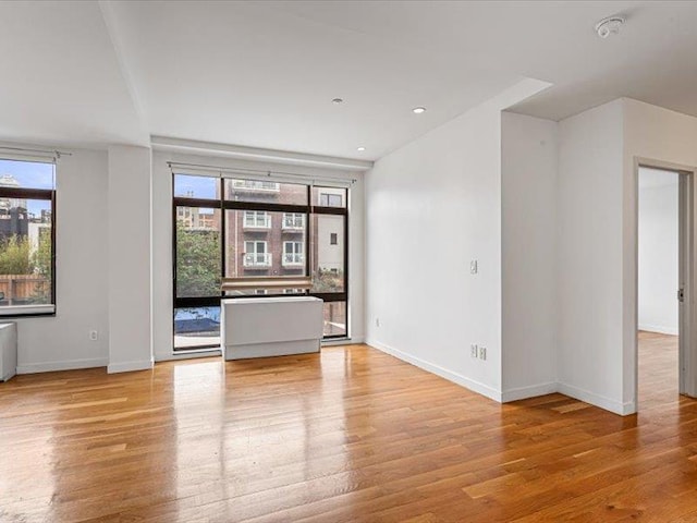 14 Hope St Unit 3F, Brooklyn, NY 11211 - unfurnished room with plenty of natural light, wood finished floors, recessed lighting, and a smoke detector
