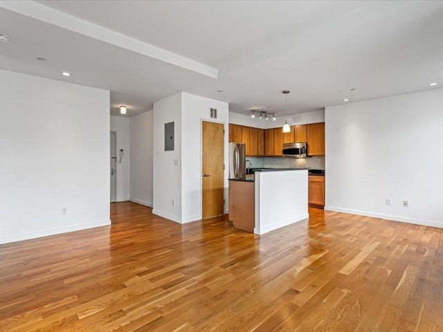 14 Hope St Unit 3F, Brooklyn, NY 11211 - unfurnished living room with light wood-style floors, track lighting, electric panel, and recessed lighting