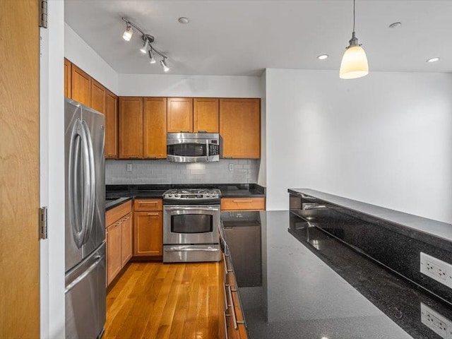 14 Hope St Unit 3F, Brooklyn, NY 11211 - kitchen featuring stainless steel appliances, brown cabinets, decorative backsplash, decorative light fixtures, and recessed lighting