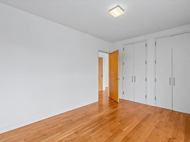 14 Hope St Unit 3F, Brooklyn, NY 11211 - unfurnished bedroom featuring multiple closets and light wood-style flooring