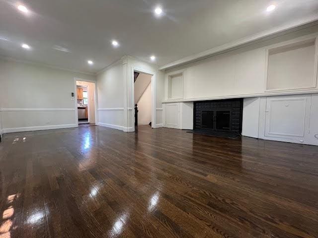 4118 Hill Ave, Bronx, NY 10466 - unfurnished living room featuring crown molding, dark wood-style floors, a fireplace, recessed lighting, and stairway