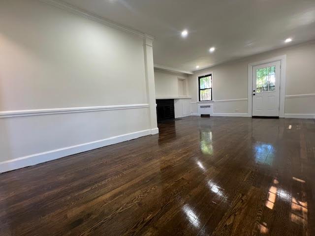4118 Hill Ave, Bronx, NY 10466 - unfurnished living room featuring dark wood-type flooring, a fireplace, recessed lighting, and crown molding