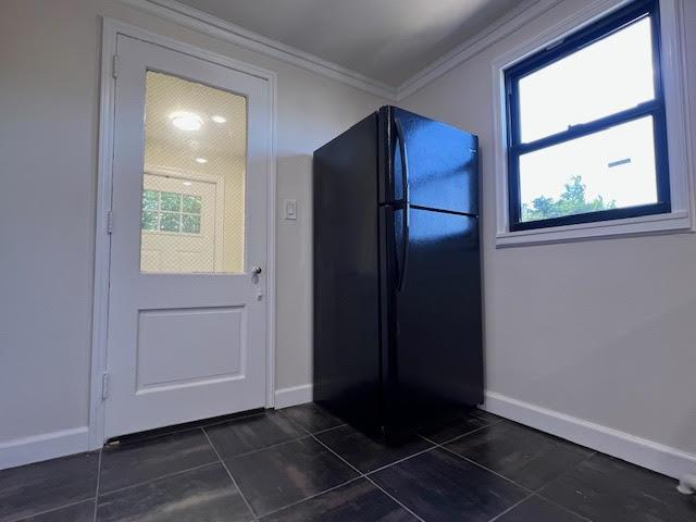 4118 Hill Ave, Bronx, NY 10466 - kitchen with freestanding refrigerator, ornamental molding, and dark tile patterned floors