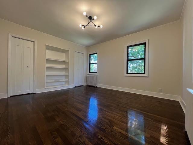 4118 Hill Ave, Bronx, NY 10466 - unfurnished bedroom featuring radiator, dark wood finished floors, two closets, a chandelier, and ornamental molding