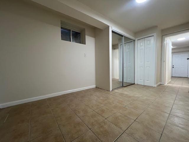 4118 Hill Ave, Bronx, NY 10466 - unfurnished bedroom featuring light tile patterned flooring and two closets
