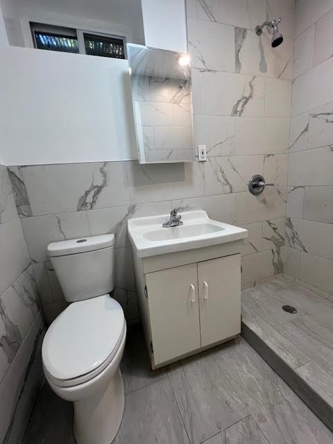 4118 Hill Ave, Bronx, NY 10466 - full bath with vanity, tile walls, a shower stall, and marble look tile flooring