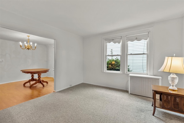 72 Putnam Ave, Valley Stream, NY 11580 - spare room with radiator heating unit, a chandelier, and carpet floors