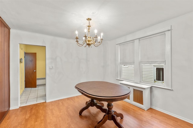 72 Putnam Ave, Valley Stream, NY 11580 - dining area with a chandelier, light wood-type flooring, radiator, and ornamental molding