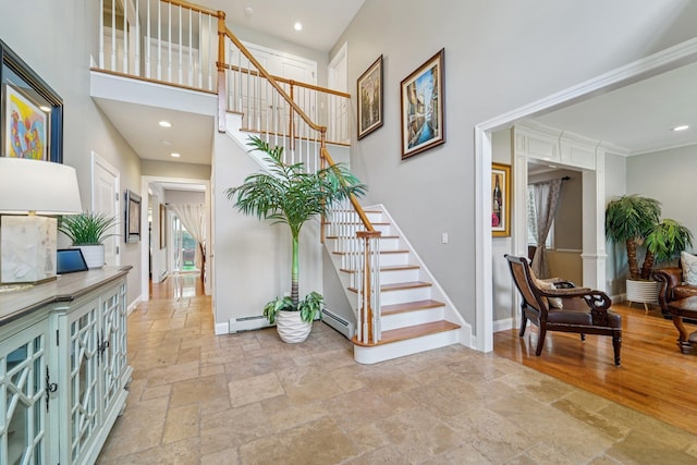 10 Willow Dr, Suffern, NY 10901 - foyer entrance with stone tile floors, stairs, recessed lighting, a high ceiling, and a baseboard heating unit