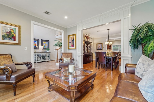 10 Willow Dr, Suffern, NY 10901 - living room featuring light wood-style floors, decorative columns, a chandelier, crown molding, and recessed lighting