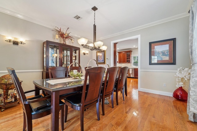 10 Willow Dr, Suffern, NY 10901 - dining room featuring a chandelier, crown molding, and light wood finished floors