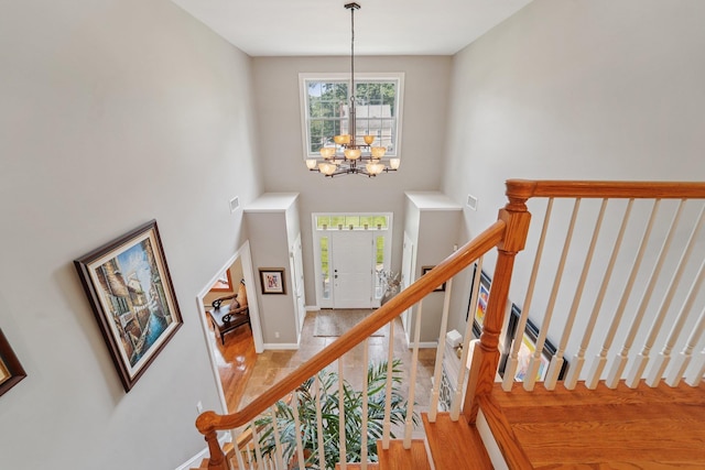 10 Willow Dr, Suffern, NY 10901 - stairway featuring a chandelier, wood finished floors, and a high ceiling