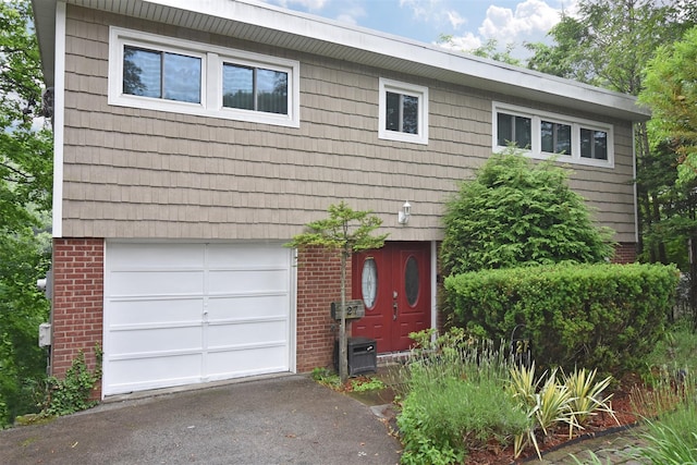 27 Temple Rd, Dobbs Ferry, NY 10522 - view of front of home with brick siding, a garage, and asphalt driveway