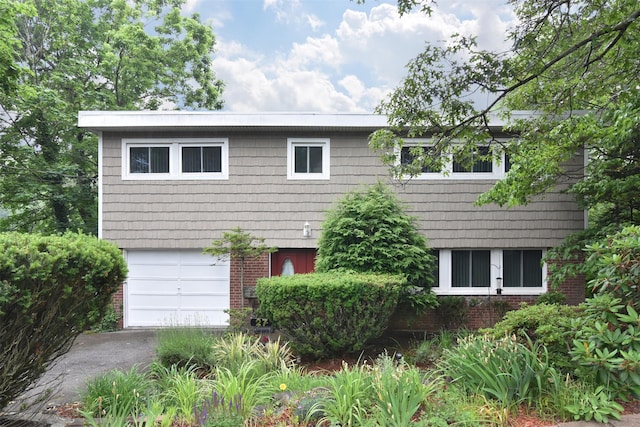 27 Temple Rd, Dobbs Ferry, NY 10522 - view of front of property featuring brick siding, an attached garage, and driveway