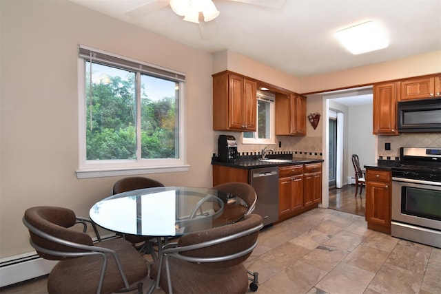 27 Temple Rd, Dobbs Ferry, NY 10522 - kitchen featuring appliances with stainless steel finishes, decorative backsplash, dark countertops, a baseboard radiator, and ceiling fan