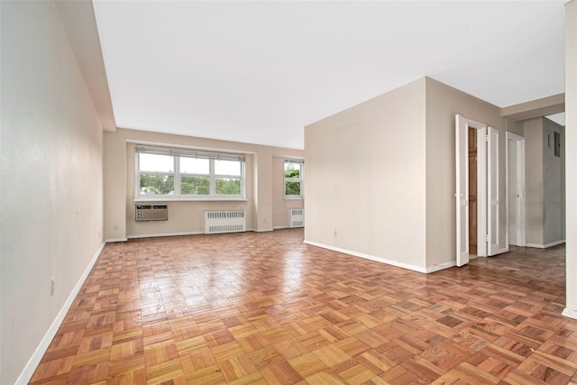 33 Barker Ave Unit 6K, White Plains, NY 10601 - spare room featuring radiator heating unit and a wall mounted air conditioner