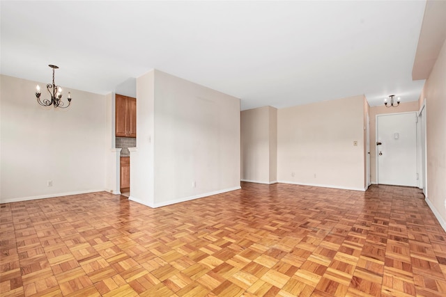 33 Barker Ave Unit 6K, White Plains, NY 10601 - unfurnished living room with a chandelier and baseboards