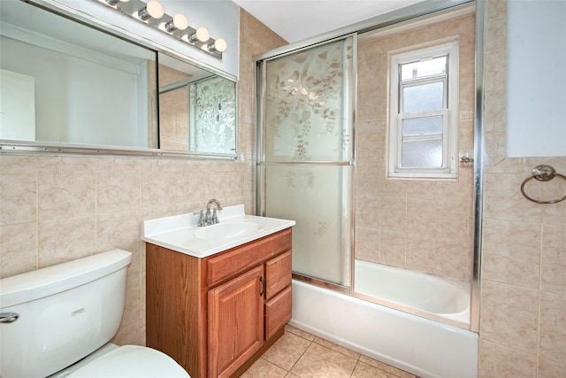33 Barker Ave Unit 6K, White Plains, NY 10601 - bathroom featuring vanity, tile walls, bath / shower combo with glass door, and tile patterned flooring